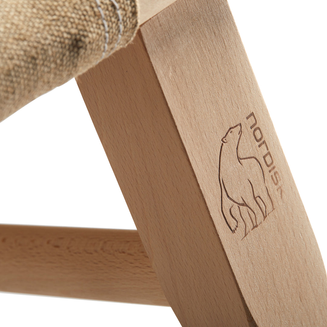 Nordisk logo bear on wooden chair leg detail
