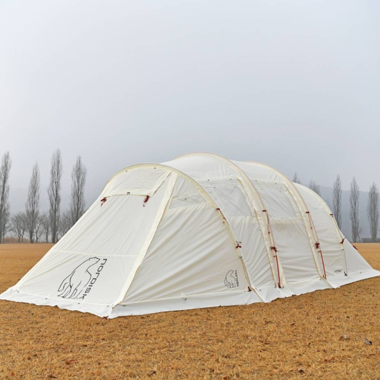 White camping tent with visible branding on a plain background