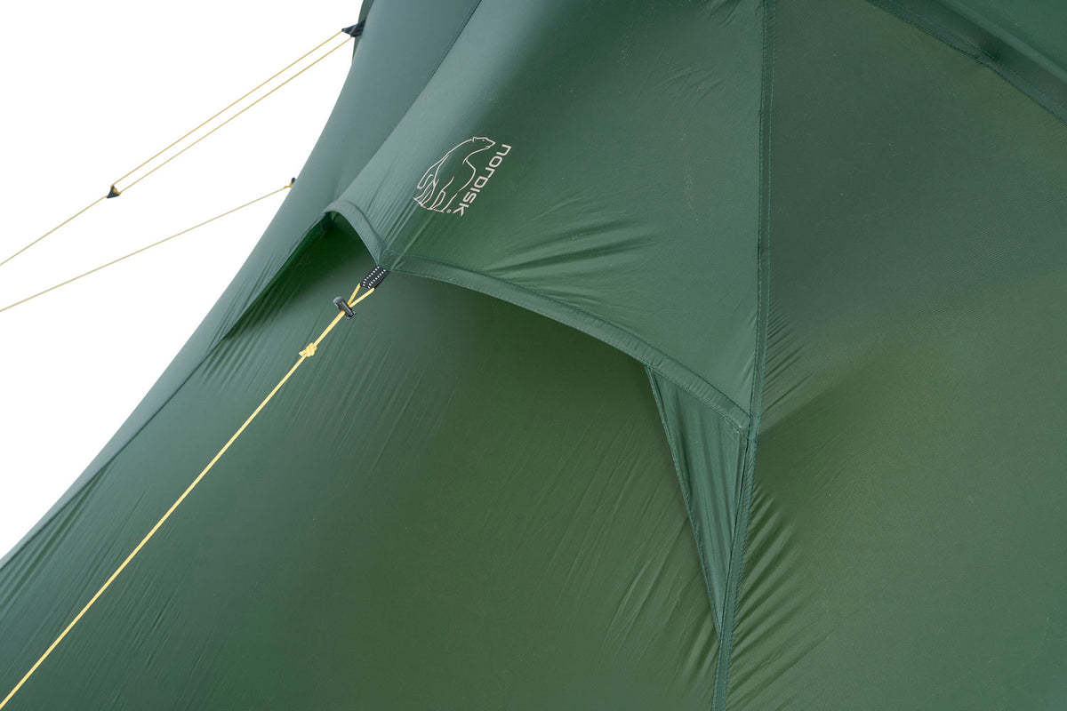 Close-up of a green tent with a brand logo on a white background