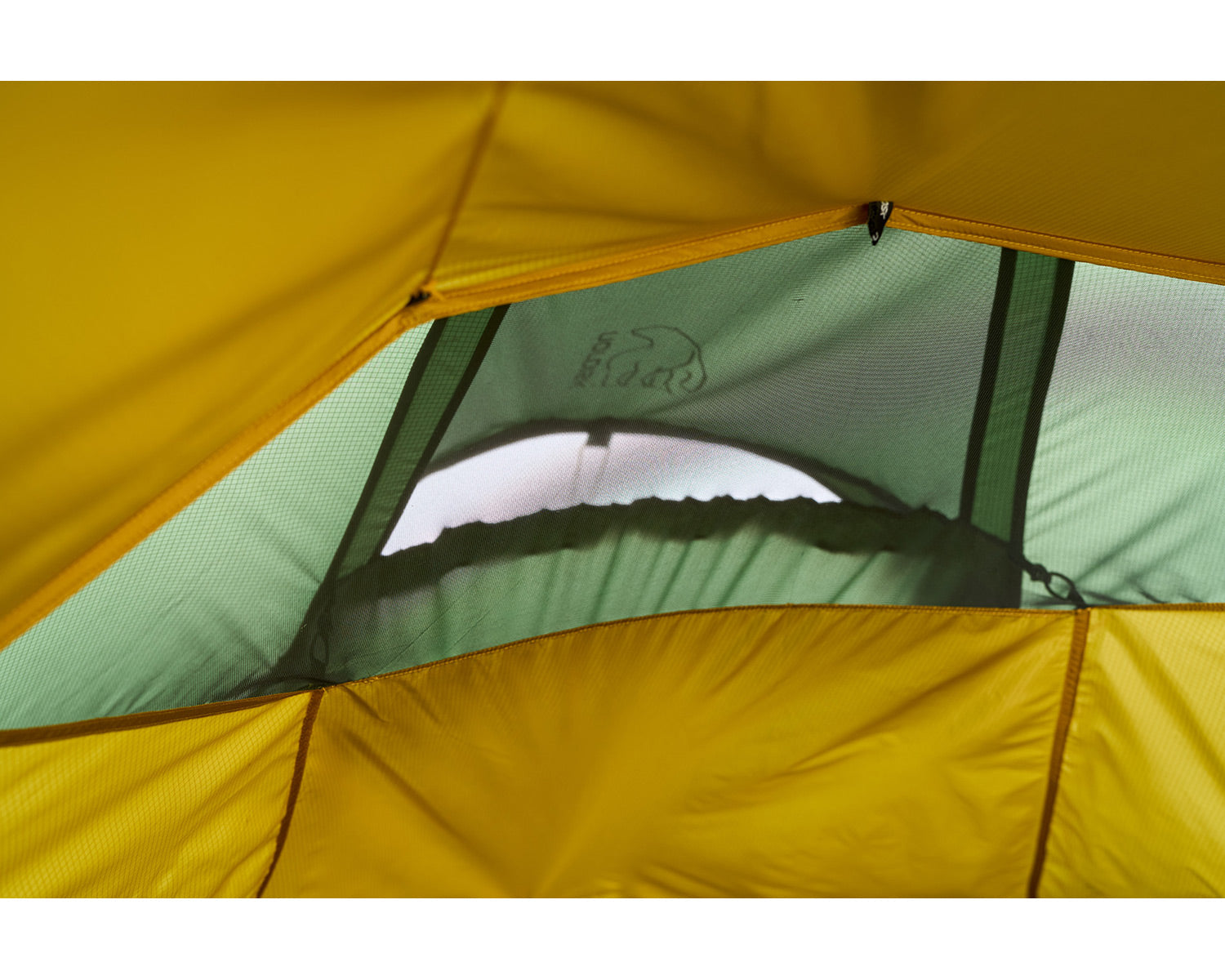 Close-up of a yellow and green tent with a brand logo.