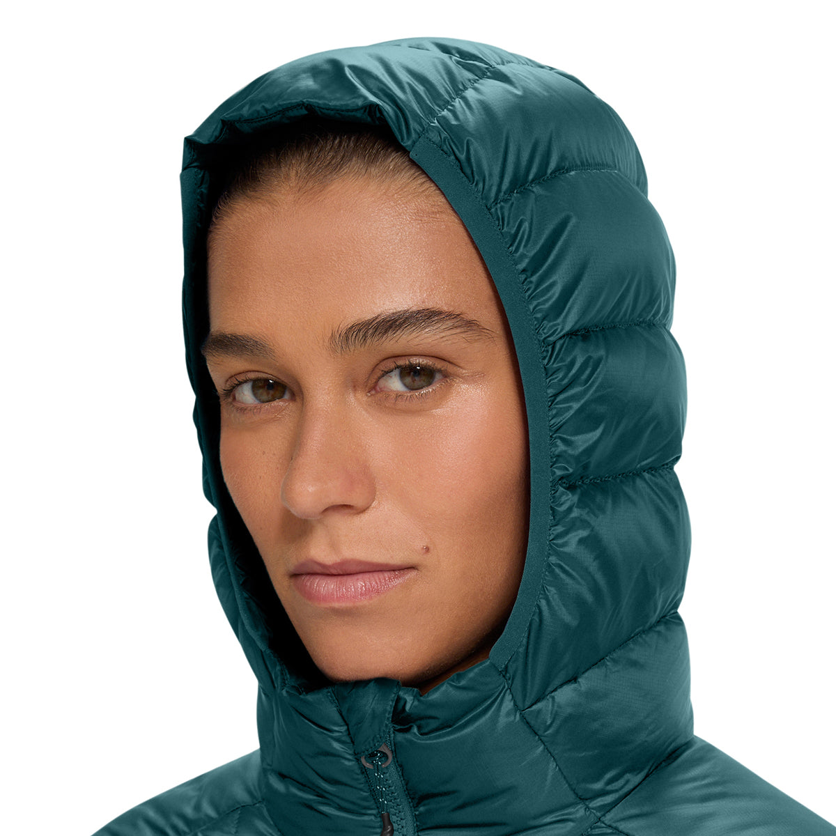 A close-up of a model wearing a dark teal-green hooded puffer jacket against a plain white background.