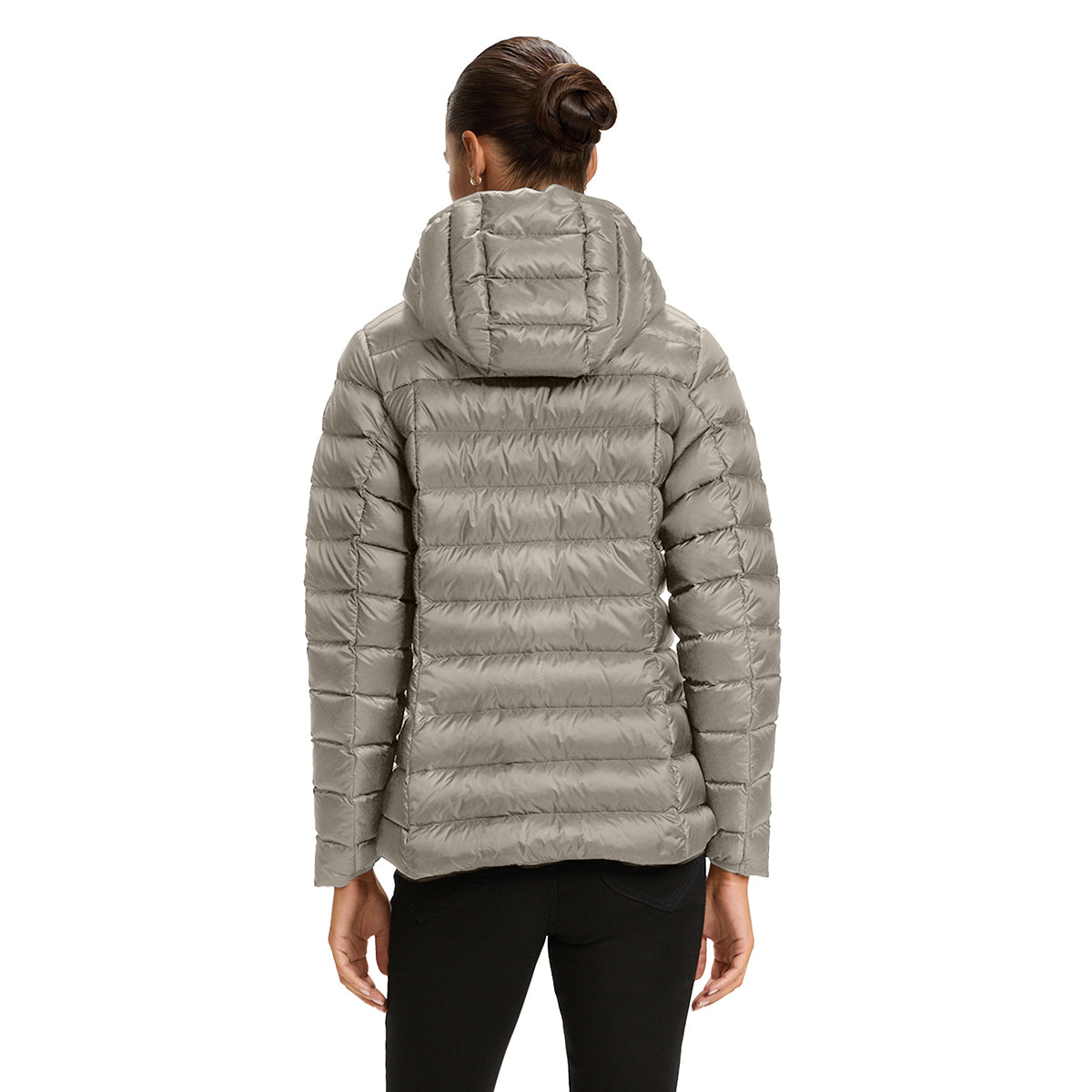 A woman viewed from the back wearing a light gray hooded puffer jacket and black pants against a plain white studio background.