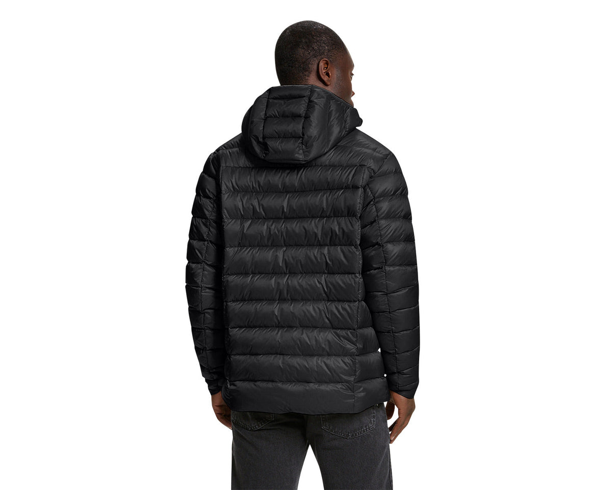 Person wearing a black puffer jacket on a white background