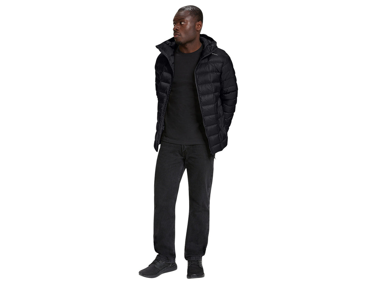 Man wearing a black puffer jacket and pants on a white background
