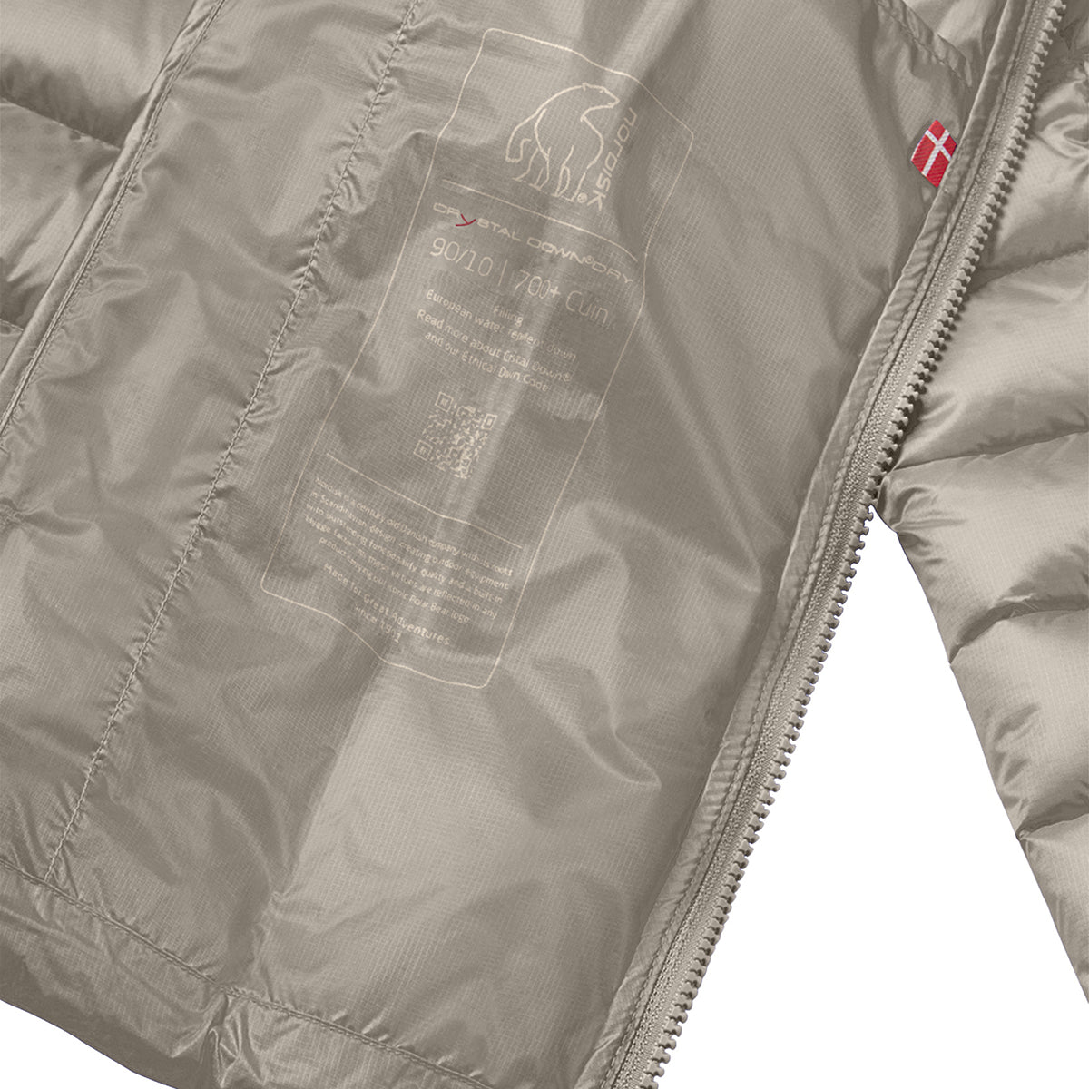 Close-up of a puffer jacket interior showing a light taupe-gray quilted lining with a printed inner label and a small red flag logo near the zipper.