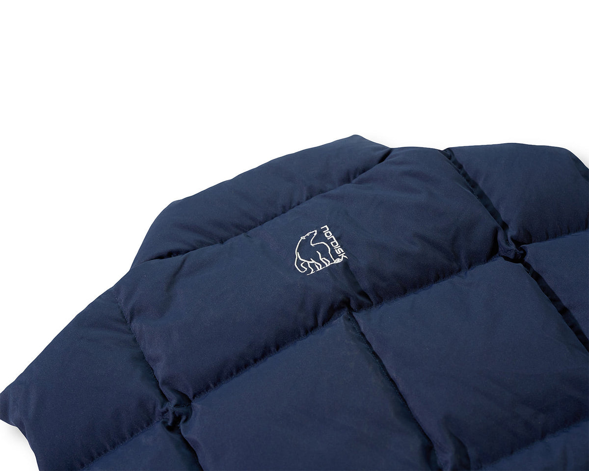 Navy blue quilt with a brand logo on a white background